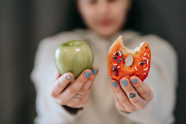 pexels-andres-ayrton-6551415 a photo of an apple and a donut
